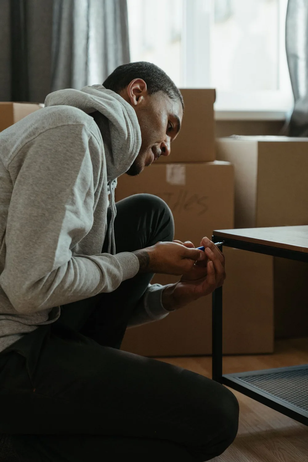 Man assembling a table at home